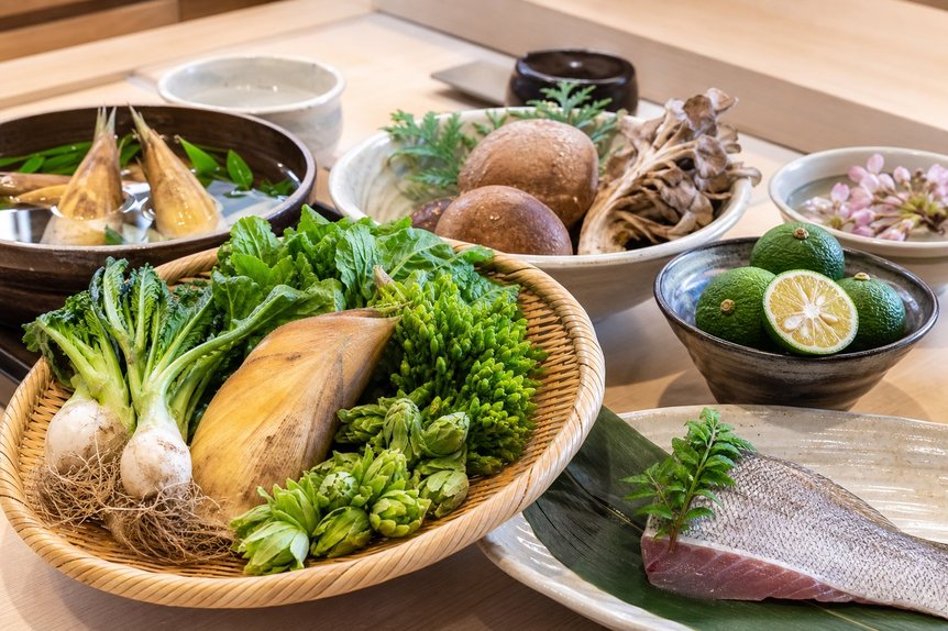 Seasonal Japanese ingredients arranged on a restaurant prep counter